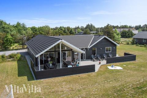 Dette eksklusive luksussommerhuset ligger i et ettertraktet sommerhusområde like ved stranden og den sjarmerende feriebyen Blåvand\r\n