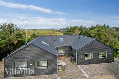 Dette lekre huset med svømmebasseng, nr. 411, med plass til 14 personer, ligger i Nordjylland