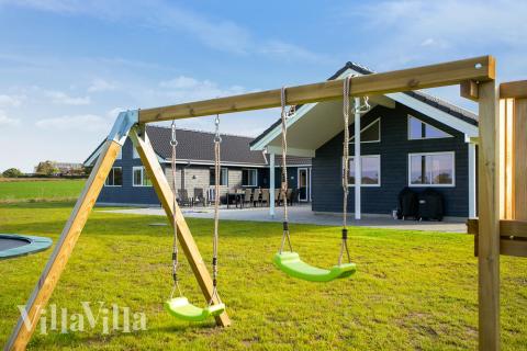 I det attraktive feriehuset nr. 447 i Lolland/Falster/Møn finnes det mengder av utendørsaktiviteter, som leketårn og huskestativ.