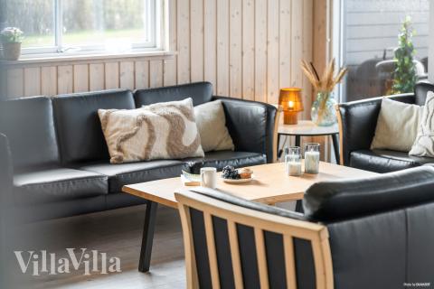Sofaen i luksushus nr. 322 i Fyn og øyer er perfekt for å hygge seg med et brettspill eller se en film sammen.